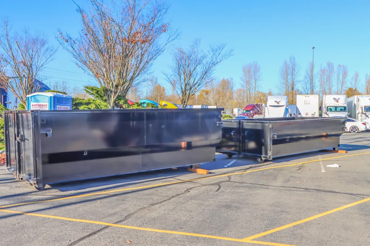 Professional dumpster rental service with roll-off container on residential driveway in Speedway